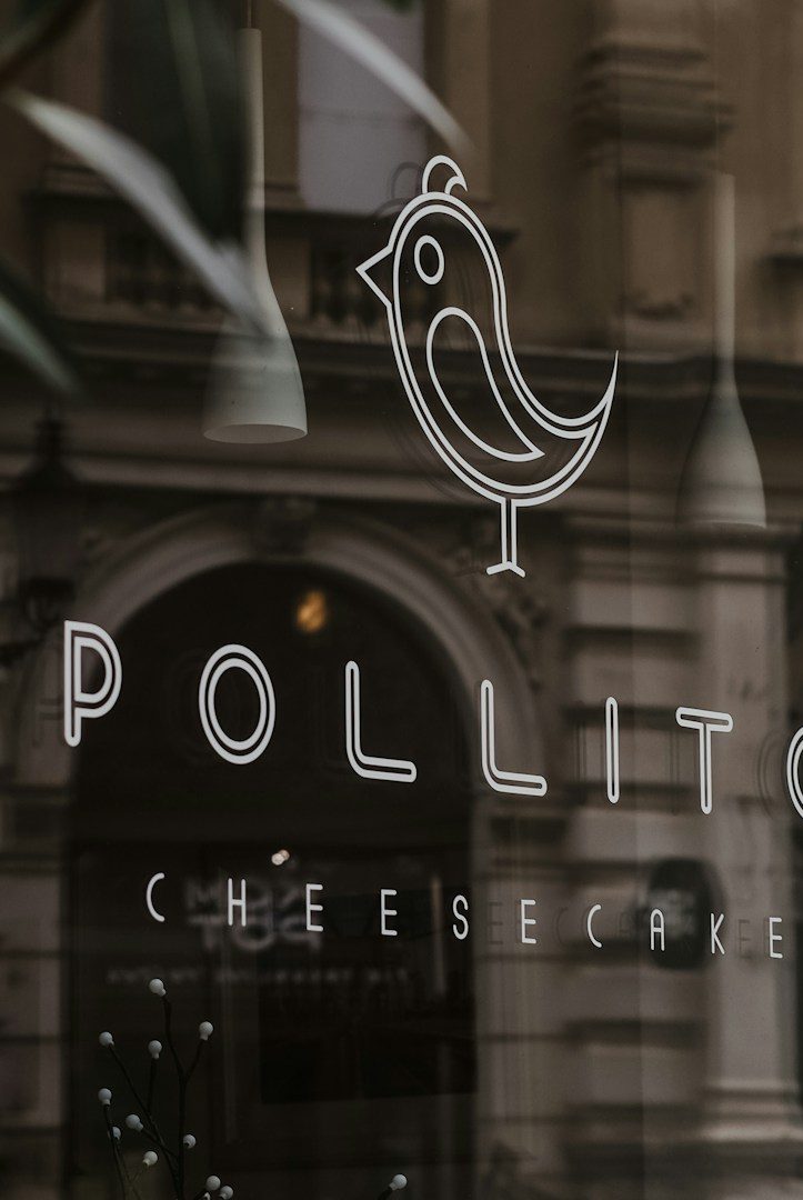 Logotipo de "Pollito Cheesecake" con un dibujo de un ave estilizada.